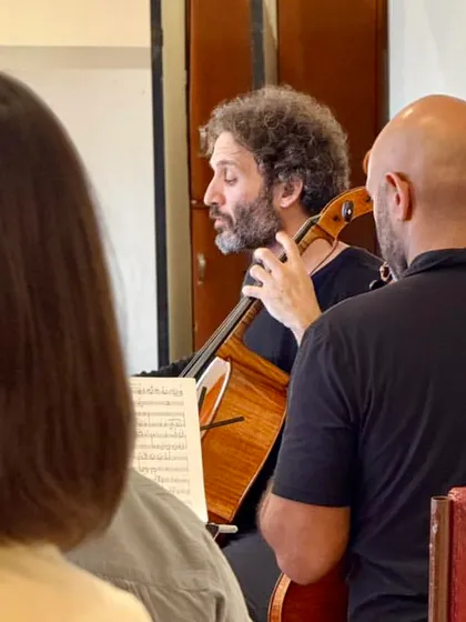 Cellist Nicolas Altstaedt leads a rehearsal section, his expressive conducting style evident even in practice.