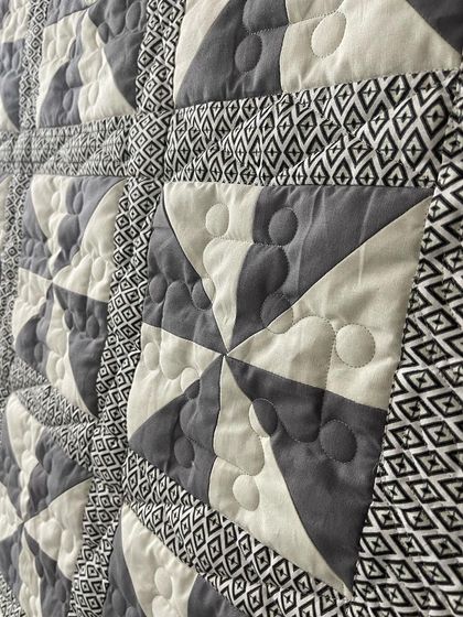 A close-up of the pinwheel blocks, showing the bubble quilting pattern.