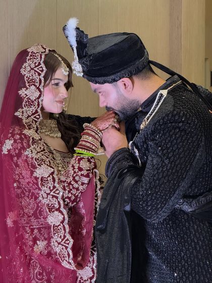 A romantic moment between the bride and groom on their Walima day. Her makeup is soft and glowing, perfect for these cherished memories.