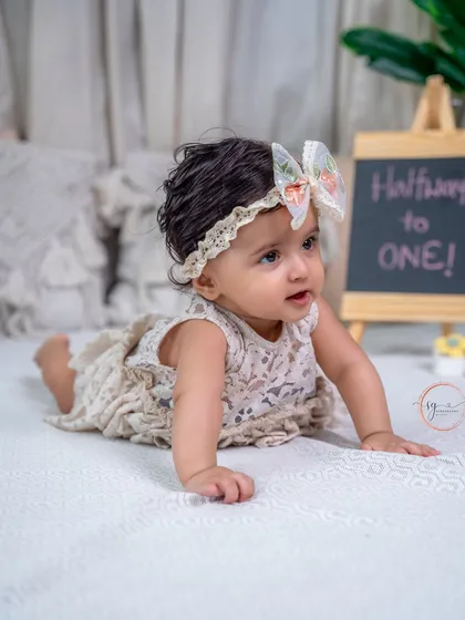 A classic tummy-time pose, showing off her strength and curiosity during her six-month photoshoot.