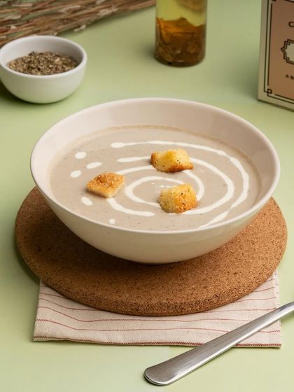 For something warm and comforting, I offer this creamy mushroom soup. It's made with fresh ingredients, garnished with a swirl of cream and crunchy croutons for texture.