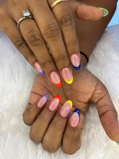 Why choose one color when you can have a rainbow? This playful design features a modern French manicure with a different bright color on each tip.