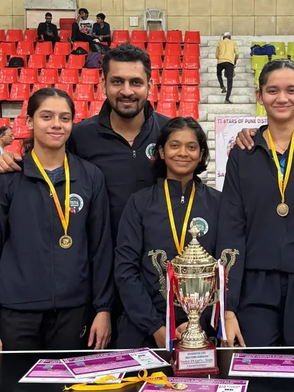 Me with our U-19 girls' team, who became Team Champions at the State Championship in Pune. Building strong teams is a key focus at our academy.