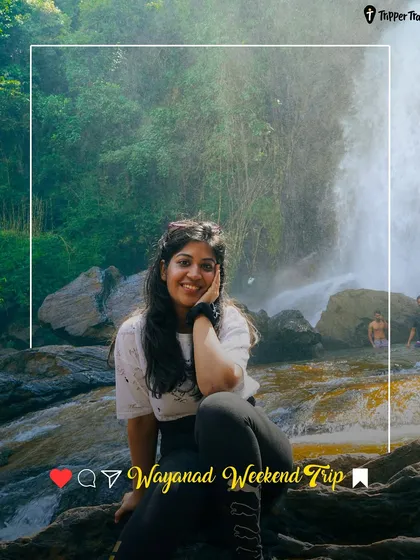 A woman smiles in front of a waterfall in Wayanad. This is the kind of happy, refreshing moment you can expect on my weekend getaways.
