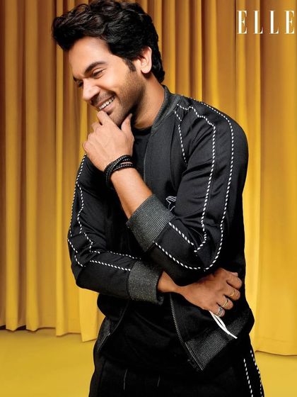 A candid, smiling shot of Rajkummar Rao for his ELLE India feature. This black Onitsuka Tiger tracksuit with contrast stitching offers a sleek, athletic alternative to the brighter looks in the spread.