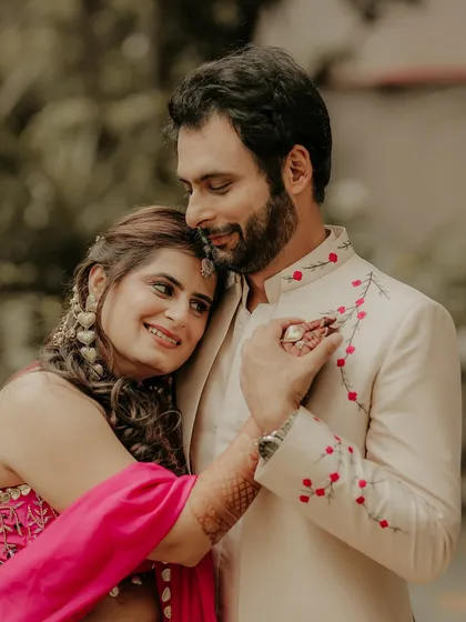 A portrait filled with warmth and affection. The bride rests her head on the groom's shoulder, a simple gesture of love and trust that makes for a beautiful, emotional photograph.