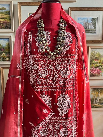 A straight-on view of the Sindoori Red suit, providing a clear look at its design.