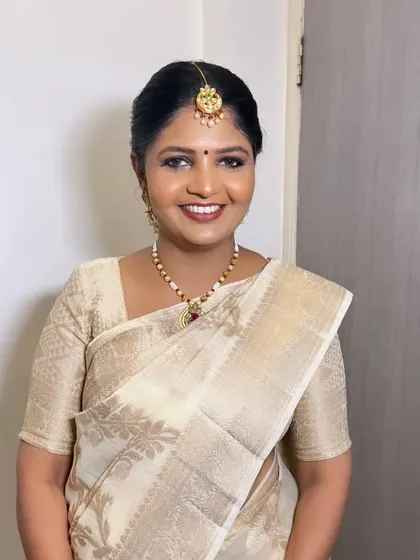 A classic South Indian look for a lovely client. The makeup is traditional and elegant, with a beautiful gold and white saree.