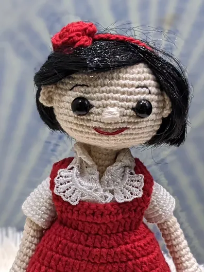 A detailed shot of the 'jija' doll's face and intricate collar work.