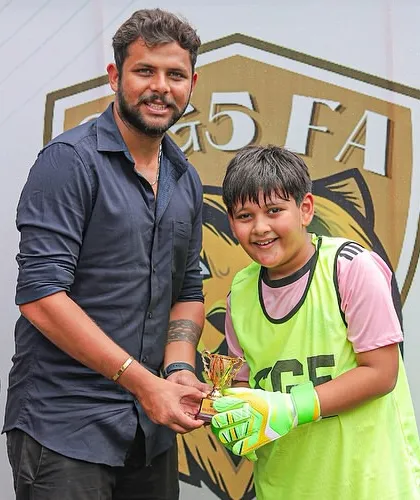 A young goalkeeper receives his Player of the Match trophy, highlighting our focus on celebrating defensive players as much as attackers.