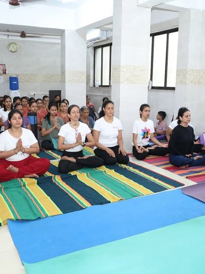 Participants in Pranamasana (Prayer Pose) at the beginning of our International Yoga Day session. We start our practice by setting an intention and cultivating a sense of gratitude.