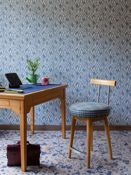 This study at Ridge View was once a guest bedroom. We reimagined it as a den and workspace, using deep blues, light oak furniture, and playful patterns. The work desk by the window is bathed in natural light, creating a perfect spot for deep focus.