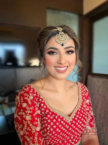 The joy on a bride's face is my greatest reward. For Jasmeet, I crafted a radiant bridal look with soft, defined eyes and a warm, glowing complexion that perfectly complemented her traditional red lehenga.