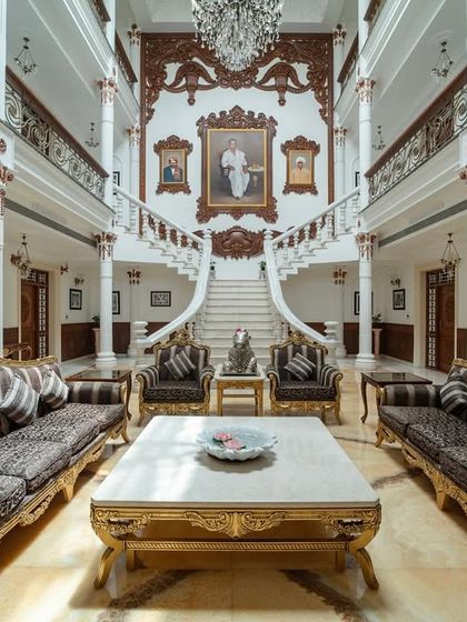 A similar perspective of the grand living room, showcasing the opulent furniture and the detailed marble flooring that complements the classical theme.