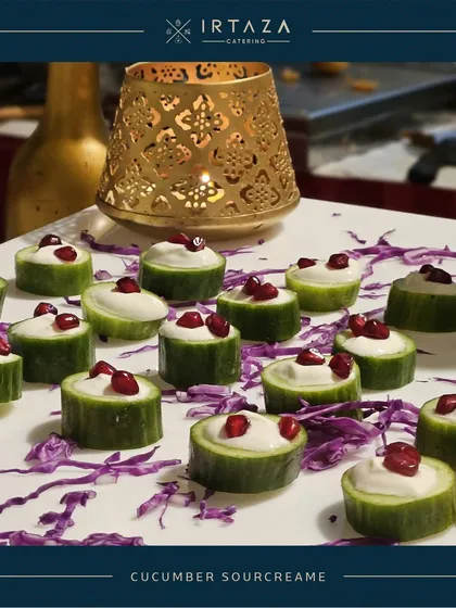 Refreshing Cucumber Sourcream bites. Crisp cucumber cups are filled with a creamy topping and garnished with pomegranate seeds, creating a light, healthy, and elegant appetizer.