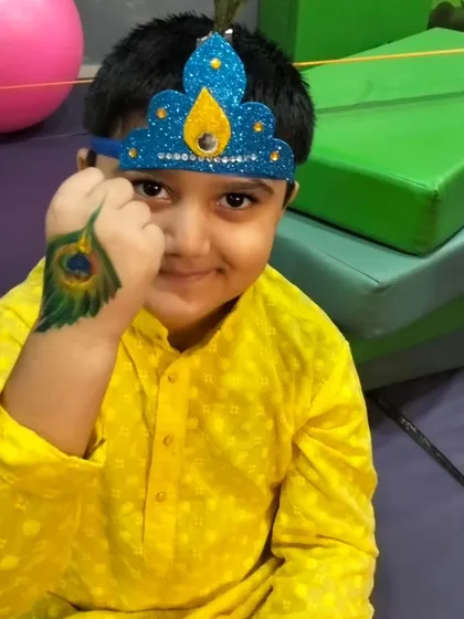 Our little Krishna for the Janmashtami celebration. He's got his handmade crown and a beautiful peacock feather painted on his hand to complete the look.