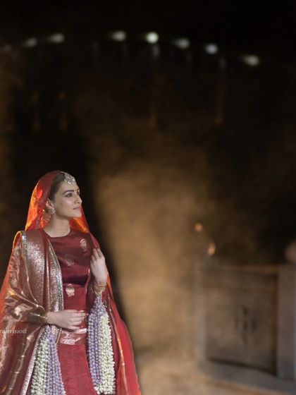 A smoky, atmospheric shot of Kriti Sanon on the ramp at the 'Dharohar Kashi Ki' show, adding a layer of mystique to her elegant look.
