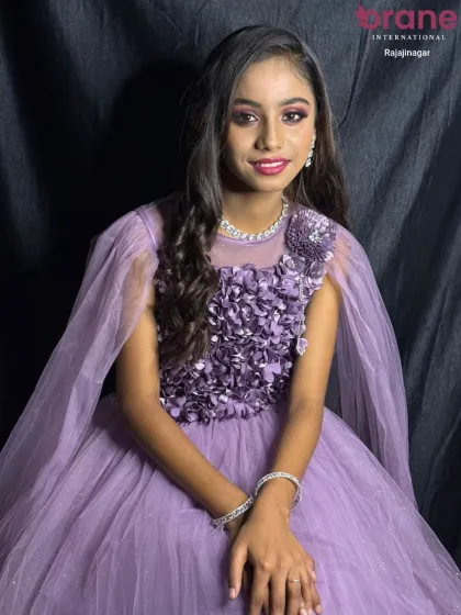 This full-length view shows how the soft, flowing curls complement the elegant party dress. Our hairstyling course covers how to create a complete and harmonious look from head to toe.