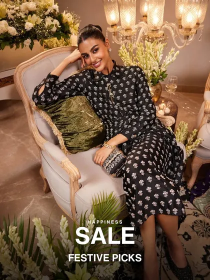 My festive picks are on sale. This model looks stunning in a black printed kurta, holding an embellished clutch, showcasing a perfect look for a Diwali party or wedding reception.