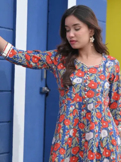 A vibrant blue kurta with a red and white floral print. The bright colors and classic A-line cut make this a cheerful and easy-to-wear piece.