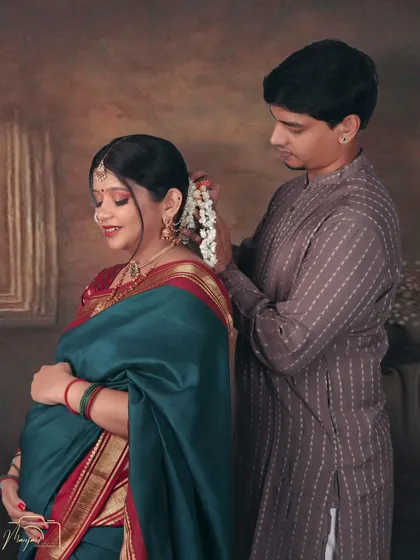 A beautiful gesture as he places flowers in her hair. An intimate and romantic moment captured in a classic style.
