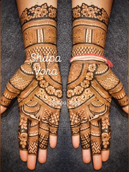 A very dense and detailed design covering the entire palm and wrist, perfect for a bride or special occasion.