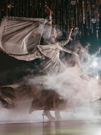 A breathtaking moment from a bride's solo performance, captured with dramatic smoke effects. We aim to create these visually stunning scenes that make for unforgettable photos.