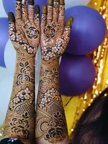 A festive shot of a full bridal henna design, perfect for capturing the celebratory mood.