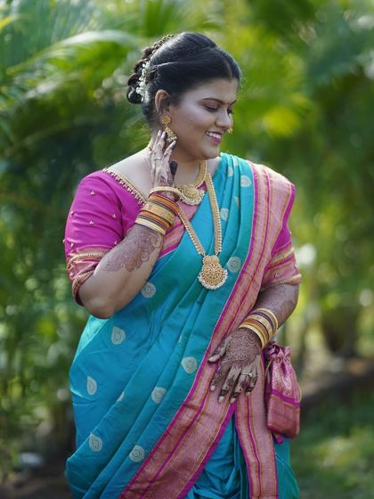 This client looks absolutely stunning in a turquoise and pink silk saree for a wedding function.