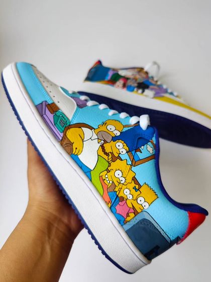 The mashup you didn't know you needed: Family Guy meets The Simpsons on a pair of custom Nike sneakers. This side features the iconic Simpsons family on their couch.