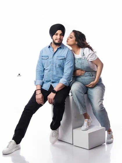 A playful and sweet moment between a couple in matching denim outfits. This fun, casual shot captures the joy and lightheartedness of their pregnancy journey.