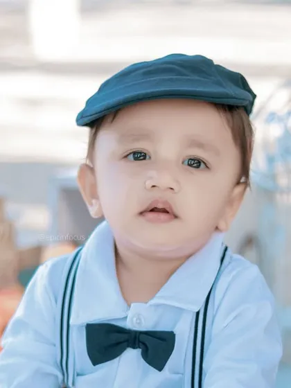 A classic, handsome portrait of a little boy in a newsboy cap. The soft, natural light of the outdoors creates a beautiful, gentle quality in the photos.