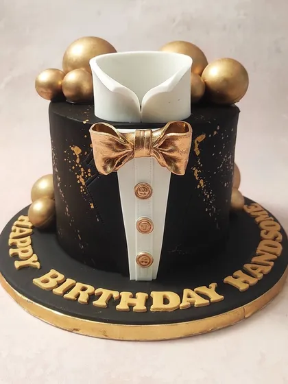 The classic black, white, and gold color palette makes this tuxedo cake a timeless choice for any formal celebration.