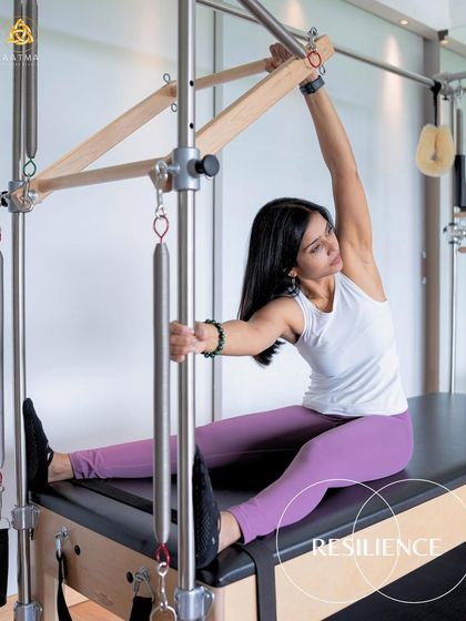 Resilience in motion. This mermaid stretch on the Cadillac not only improves spinal flexibility but also requires core strength to maintain the position with control.