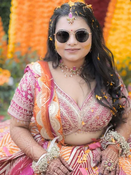Another beautiful close-up of the bride. Her makeup is designed to be subtle and long-lasting, perfect for the fun and messy Haldi ceremony.
