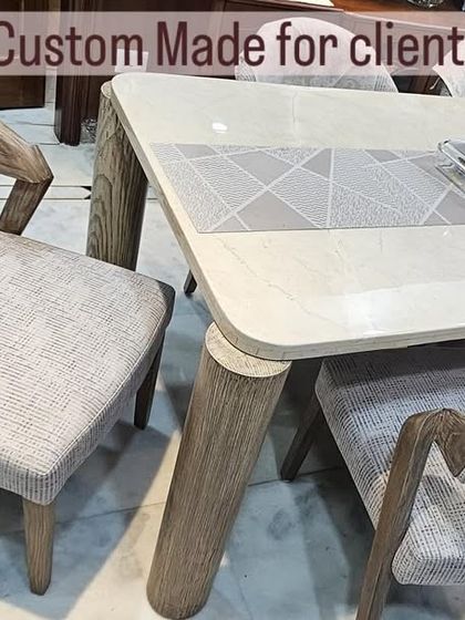 Custom-made for the client's space, this image shows the detail of the open-grain finish on the chair's armrest and the smooth, modern tabletop.