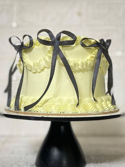 A side profile of the trendy yellow and black bow cake.