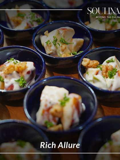 Rich allure in a bowl. This dish features tender pieces of fruit and walnuts in a creamy sauce, offering a perfect balance of textures and flavours.