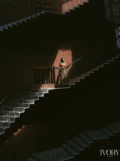 An architectural bridal portrait. We used the repeating patterns of this grand staircase and dramatic lighting to create a unique and powerful image of the bride.