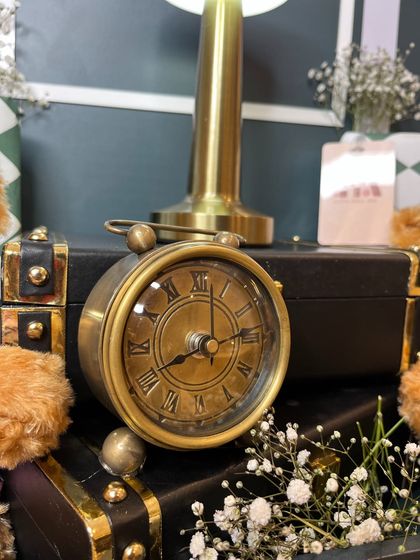 A close-up of the vintage-style clock, a thoughtful keepsake included in the hamper for Isha Ambani's twins.