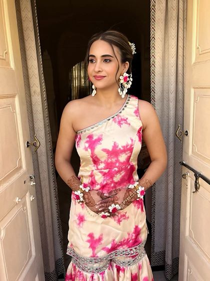 The client looks beautiful and happy with her unique floral braid. This hairstyle is a perfect blend of traditional and bohemian styles.