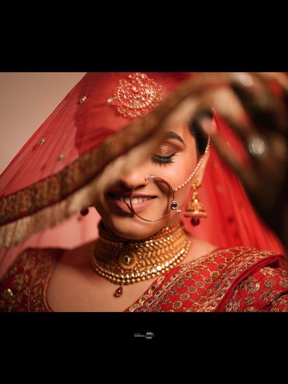 A beautiful close-up of the bride, her face partially veiled. This soft, romantic shot highlights her delicate features and the traditional bridal look.