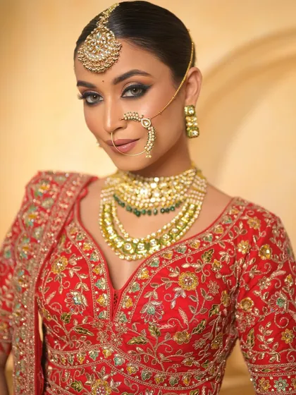 A confident gaze from our red bride. The sharp, smoked-out eyes and defined features create a look that is both bold and beautiful.
