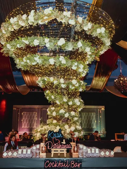 A statement piece that became the heart of the party. We designed and built this floral tornado chandelier as a central bar installation, creating a dramatic focal point that was wild, whimsical, and full of energy.