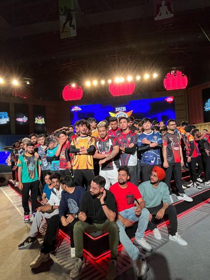 E-sports players and teams gather for a group photo on the custom-built stage. We are the chosen venue for the biggest names and teams in the Indian gaming community.