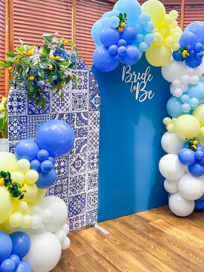 An aesthetic bridal shower decor inspired by Mediterranean tiles, with a blue and yellow color palette and lemon accents for a fresh, unique look.