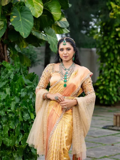 This look from my 'Athiloka Sundari' series features me in a pure Kanchi saree. I paired it with a blouse adorned with intricate embroidery and semi-precious stone embellishments, creating a regal outfit designed to make any bride feel like a princess.