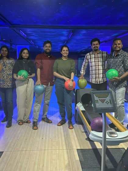 A corporate group gets ready for some bowling action. We offer packages that are perfect for team outings, combining different games to keep everyone engaged.