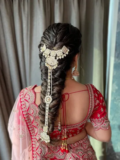 This hairstyle is perfect for a bride who wants the elegance of an updo but the length of open hair. The textured braid is a beautiful and practical choice.