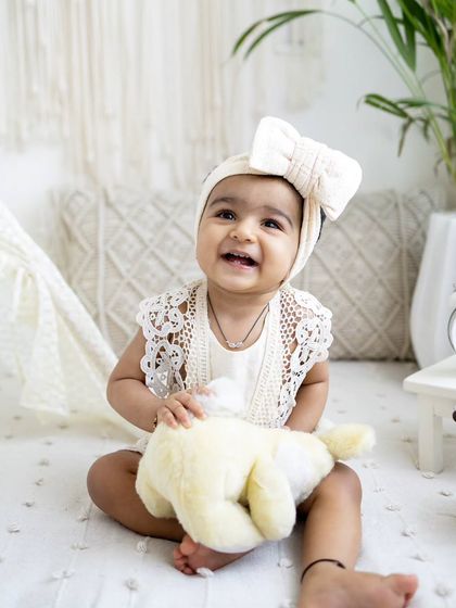 A simple and beautiful sitter session with a neutral, bohemian theme. Her happy smile lights up this minimalist setup.